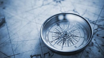 Compass and road map symbolizing how a marketing strategy defines what is possible and gives the roadmap for achieving it.