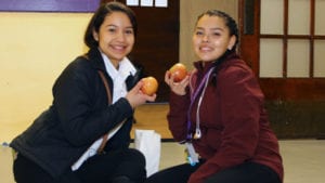 Cristo Rey Kansas City students show off the apples they received as part of the Apple a Day program. 