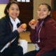 Cristo Rey Kansas City students show off the apples they received as part of the Apple a Day program.