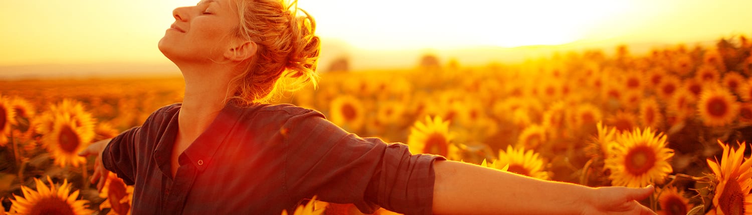 An image of a woman breathing easy in a sunflower field, used for a respiratory care creative campaign
