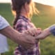 A sunkissed image of a family in a rural landscape.
