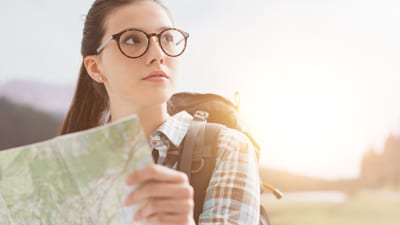 Image of a woman with a map, illustrating the quest for improved decision-making.