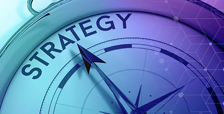 A compass pointing to “STRATEGY” as a symbol of strategy-first marketing
