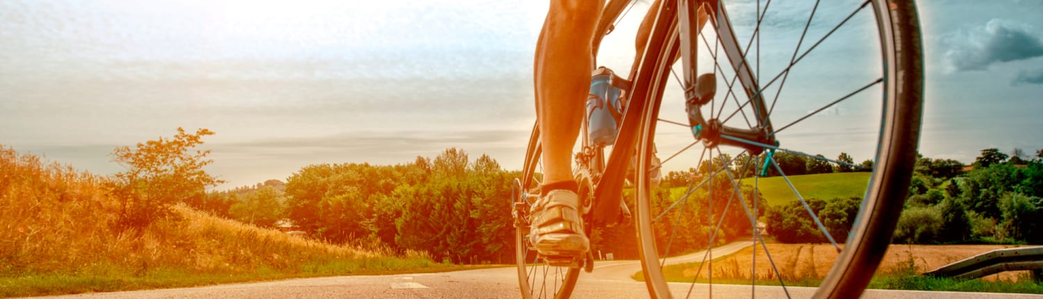 An image of a cyclist on a rural pathway